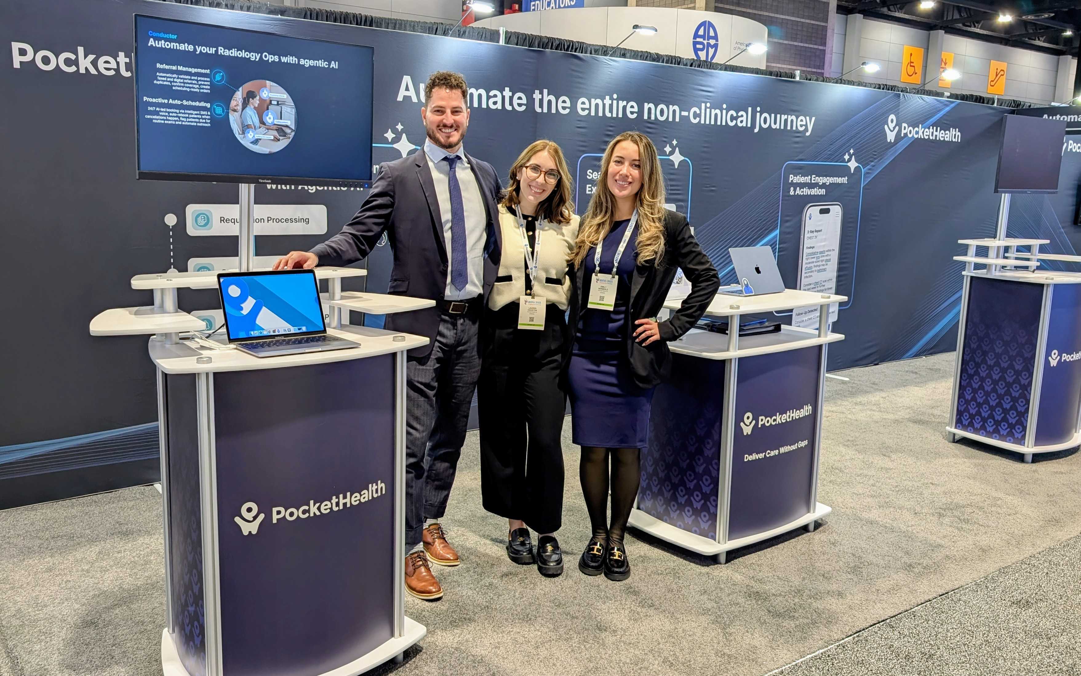 A photo of 3 employees from PocketHealth standing at a PocketHealth themed vendor booth.